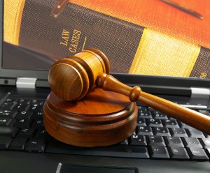 a judge's gavel placed on top of laptop keyboard