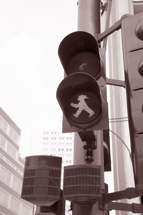 walk signal lit up on intersection signals 