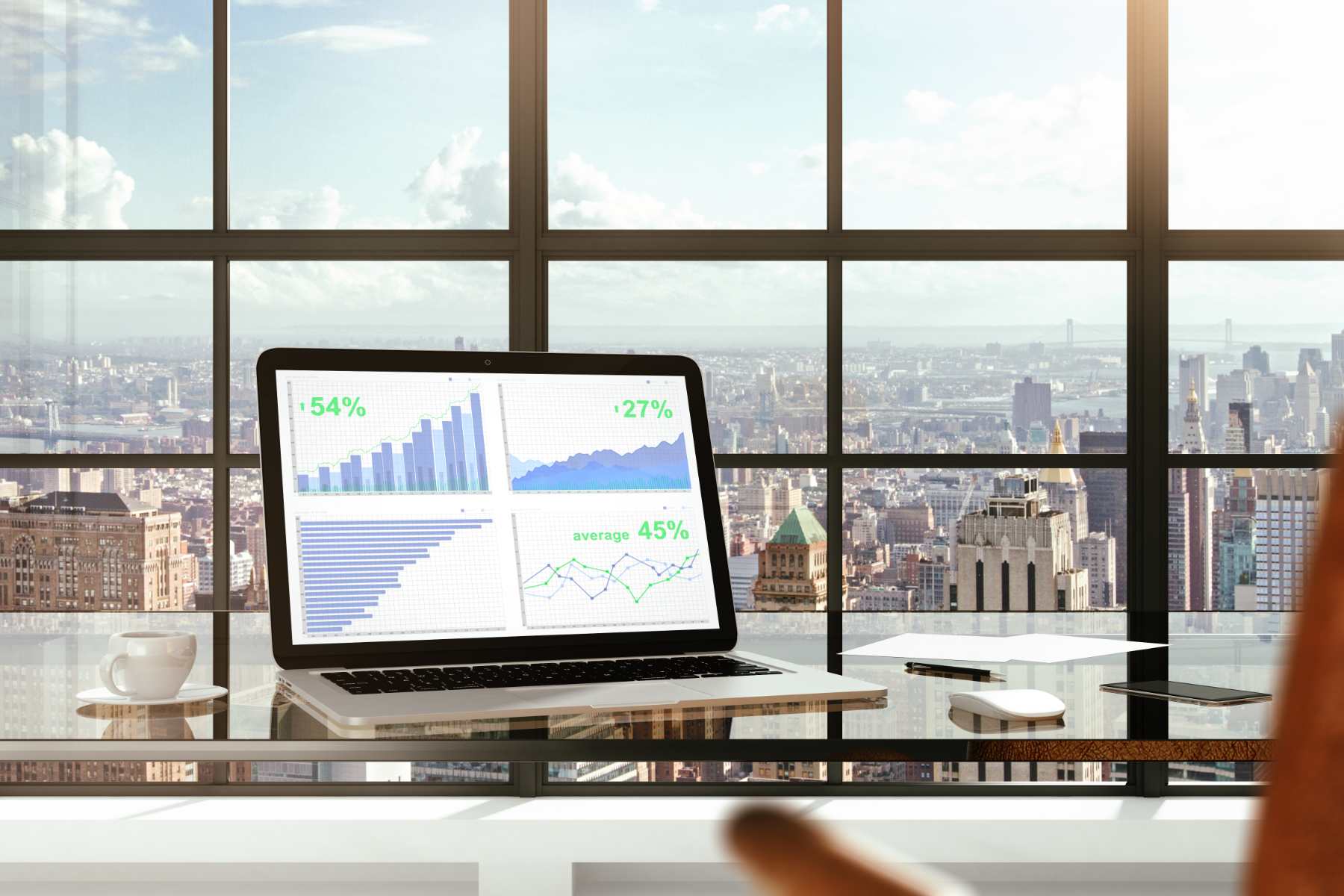 laptop with graphs featuring view from company building in city