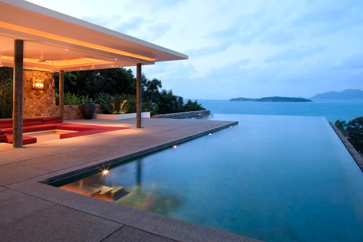 backyard overlooking water - with an infinity pool and outdoor conversation pit