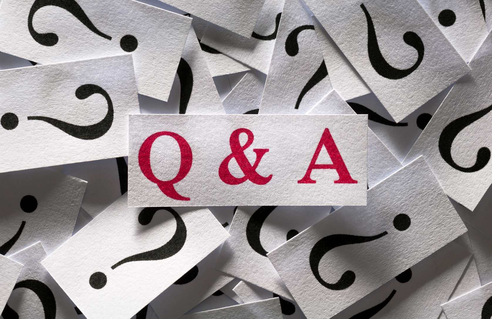 Q&A notecard and question marks graphic