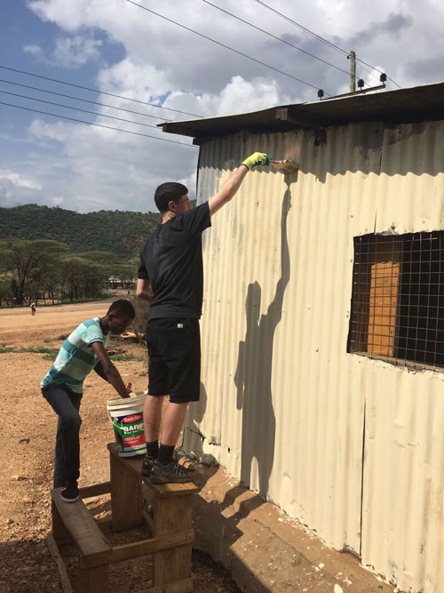 photo from Kenya service project - man painting house