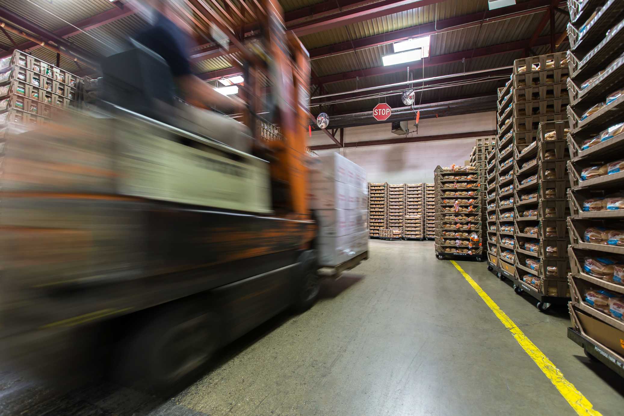 forklift moving fast in warehouse