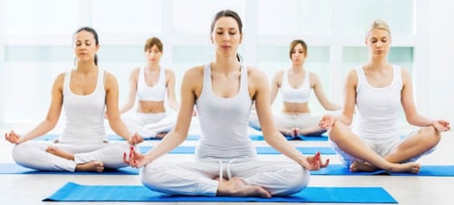 5 girls doing yoga/meditation