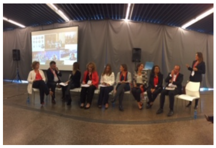 employees sitting in chairs at a panel