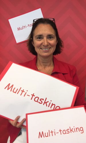 woman holding multi-tasking signs