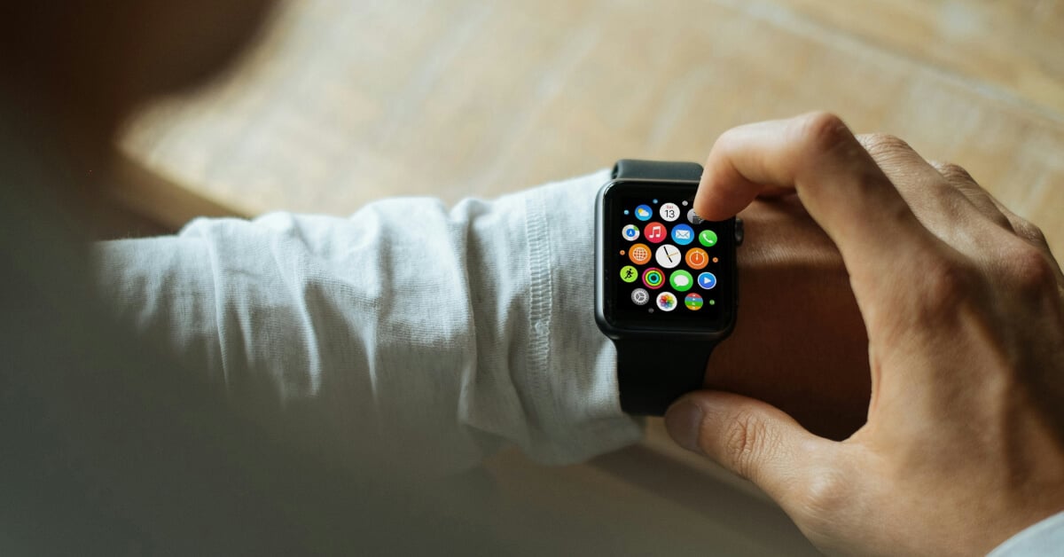 Closeup shot of a person interacting with a Apple Watch on their left wrist.