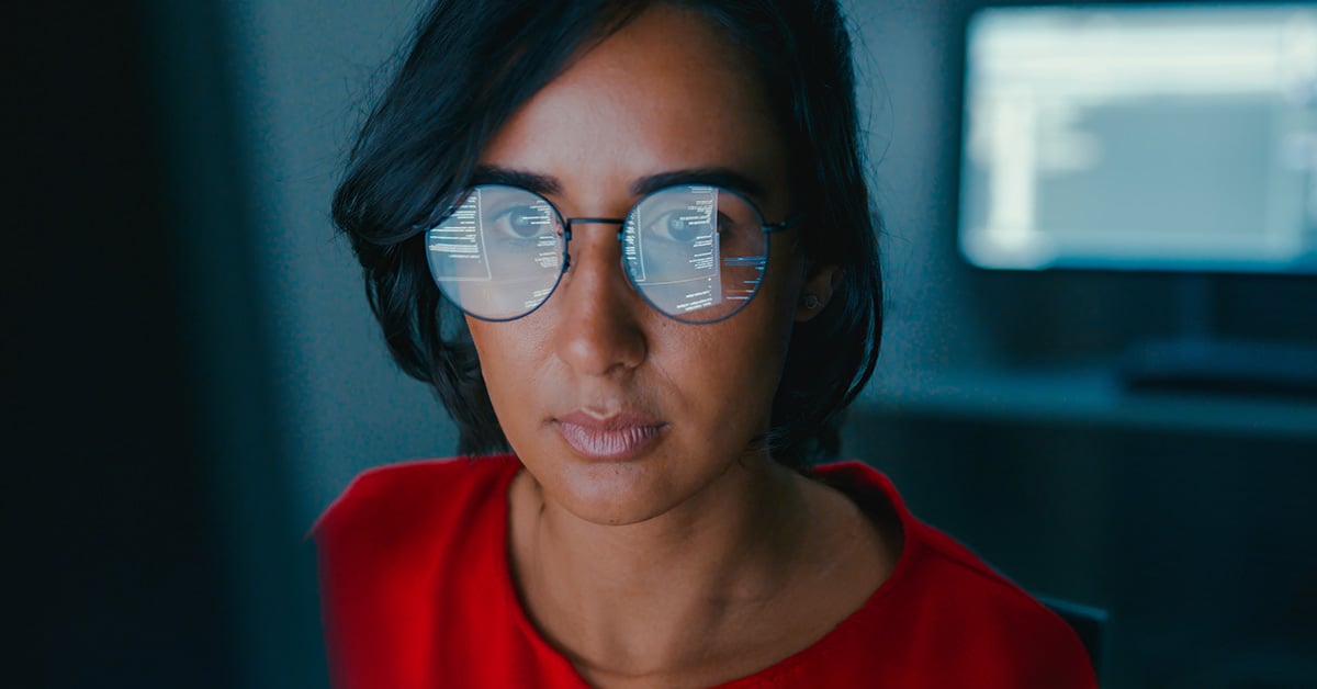 Woman wearing glasses looking at a monitor