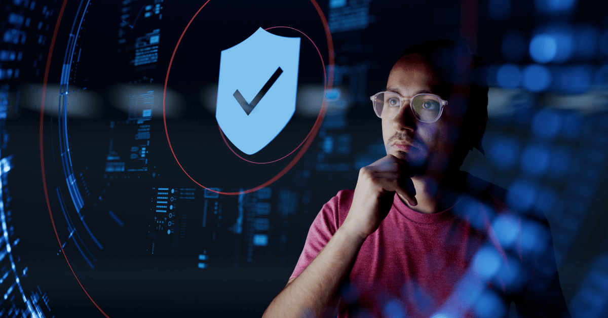 Large blue shield with checkmark icon overlays a digital background filled with abstract blue circuitry and data patterns; a person wearing a red shirt is positioned in the foreground