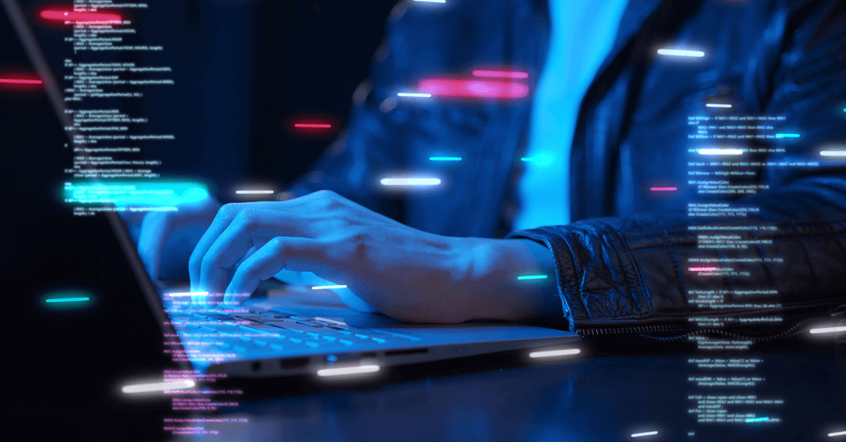 Hands typing on a laptop keyboard with glowing lines of code and neon light streaks floating in the foreground and background. The person is wearing a dark leather jacket, and the scene is illuminated