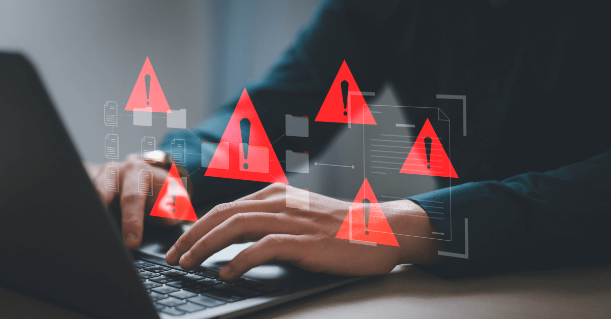 Hands on a keyboard with translucent UI panels and multiple red triangular warning icons with exclamation marks, suggesting active security alerts while working on a computer.