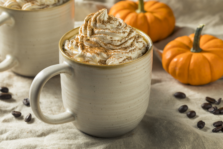a cup of pumpkin coffee with whipped cream on top