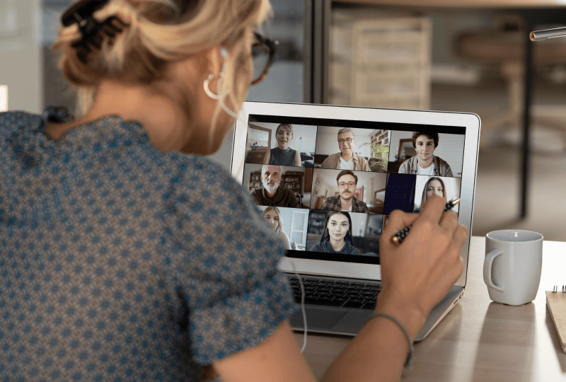 Woman on a video call with multiple people.