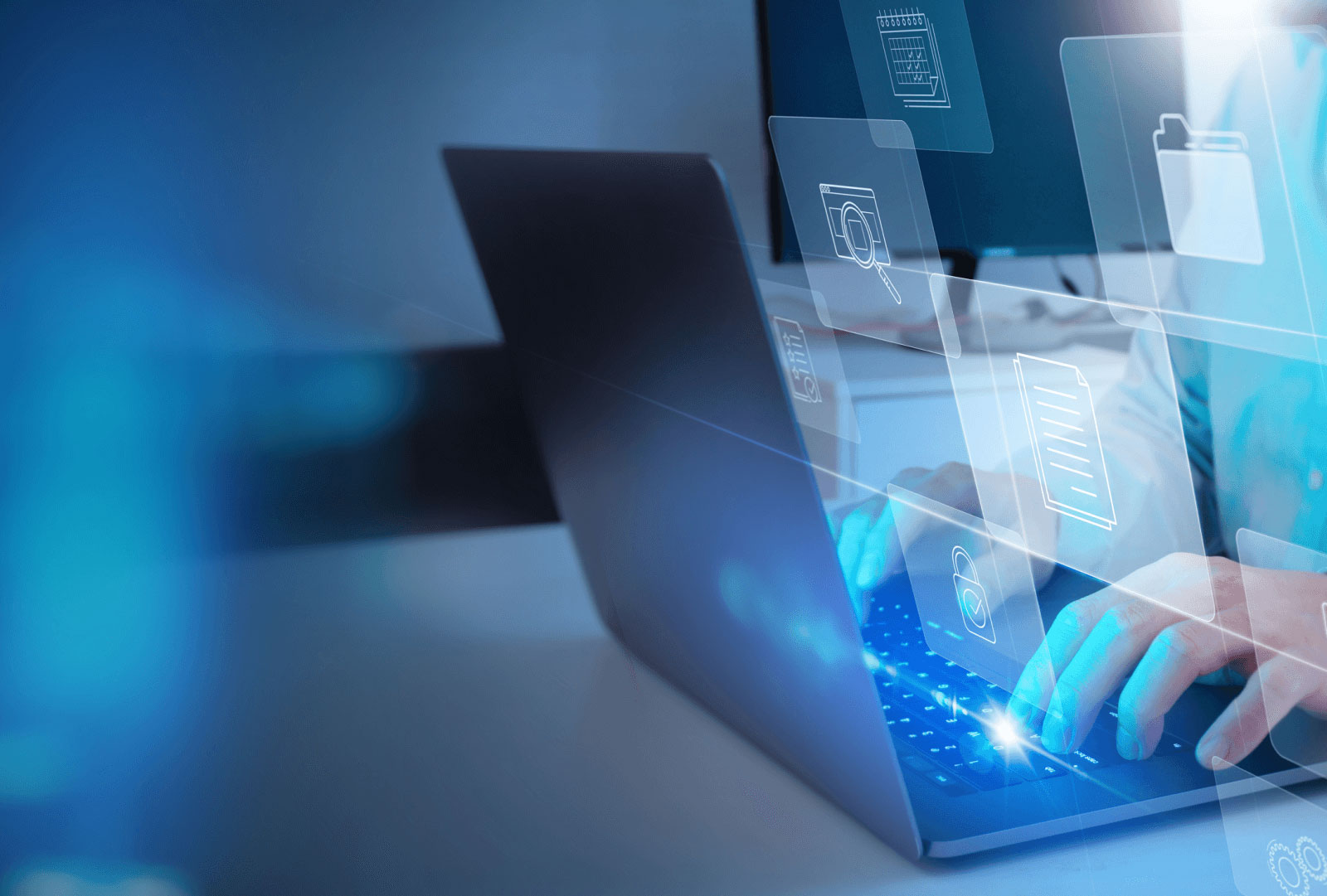 Hologram of apps floating above a laptop keyboard.