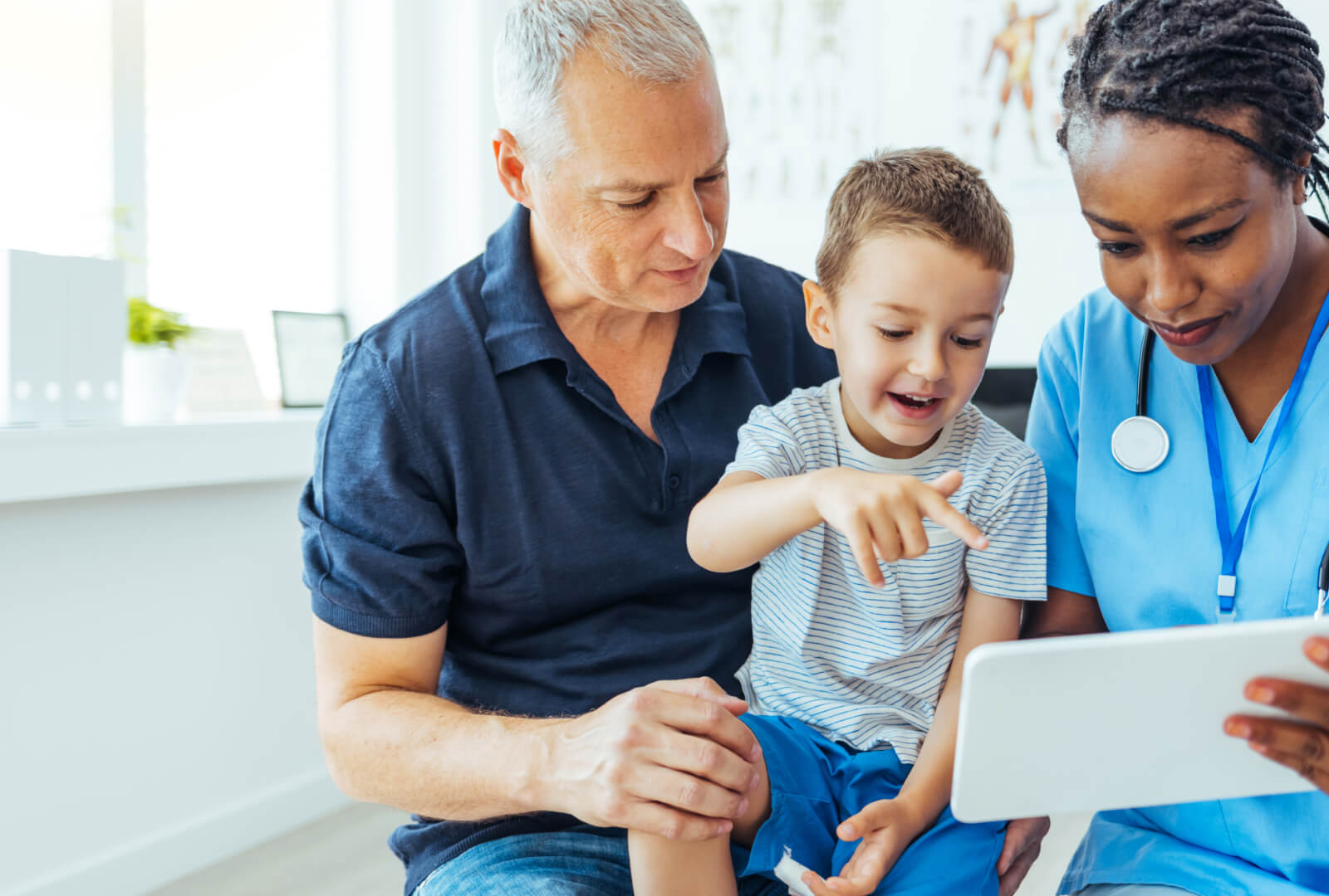 man and child and nurse in a hospital