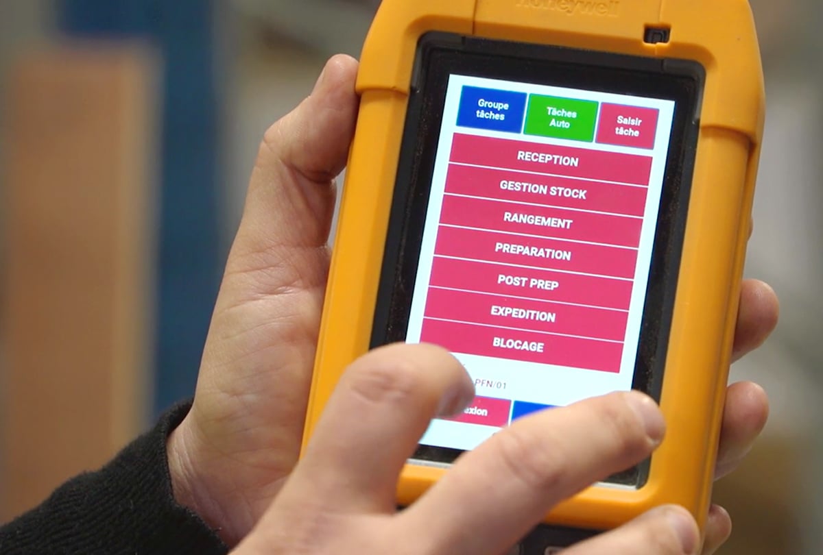 Closeup of a persons' hands interacting with a rugged tablet device.