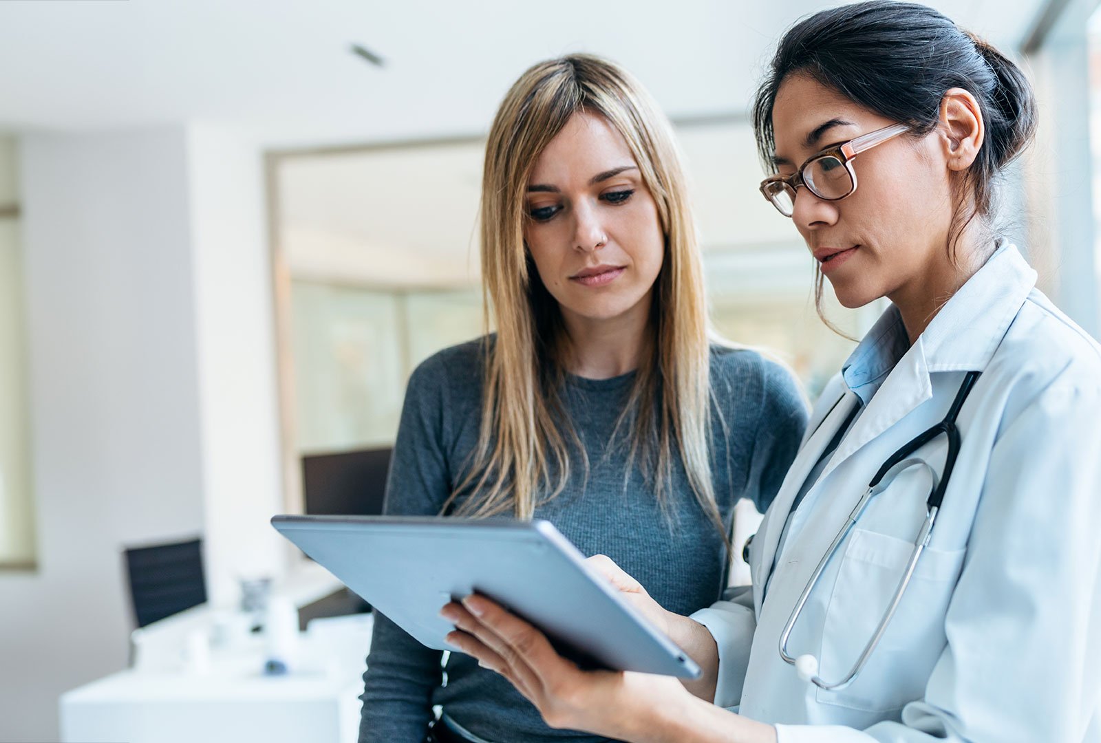 doctor and patient looking at diagnostic results on a tablet