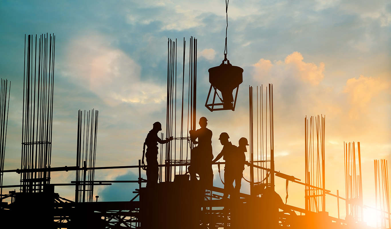 construction workers on a skyscraper rooftop