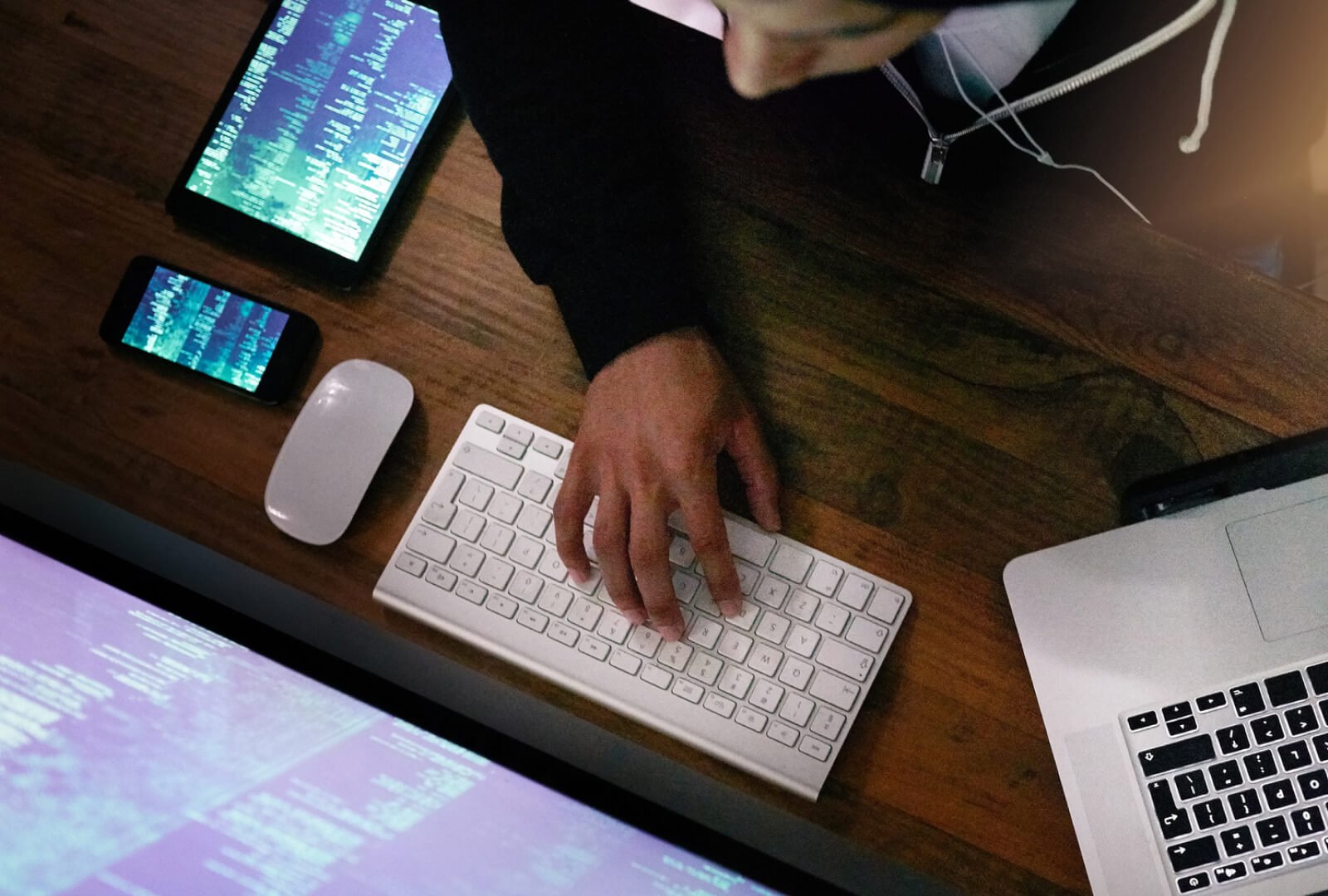 Aerial shot of a person at a computer desk interacting with a keyboard.