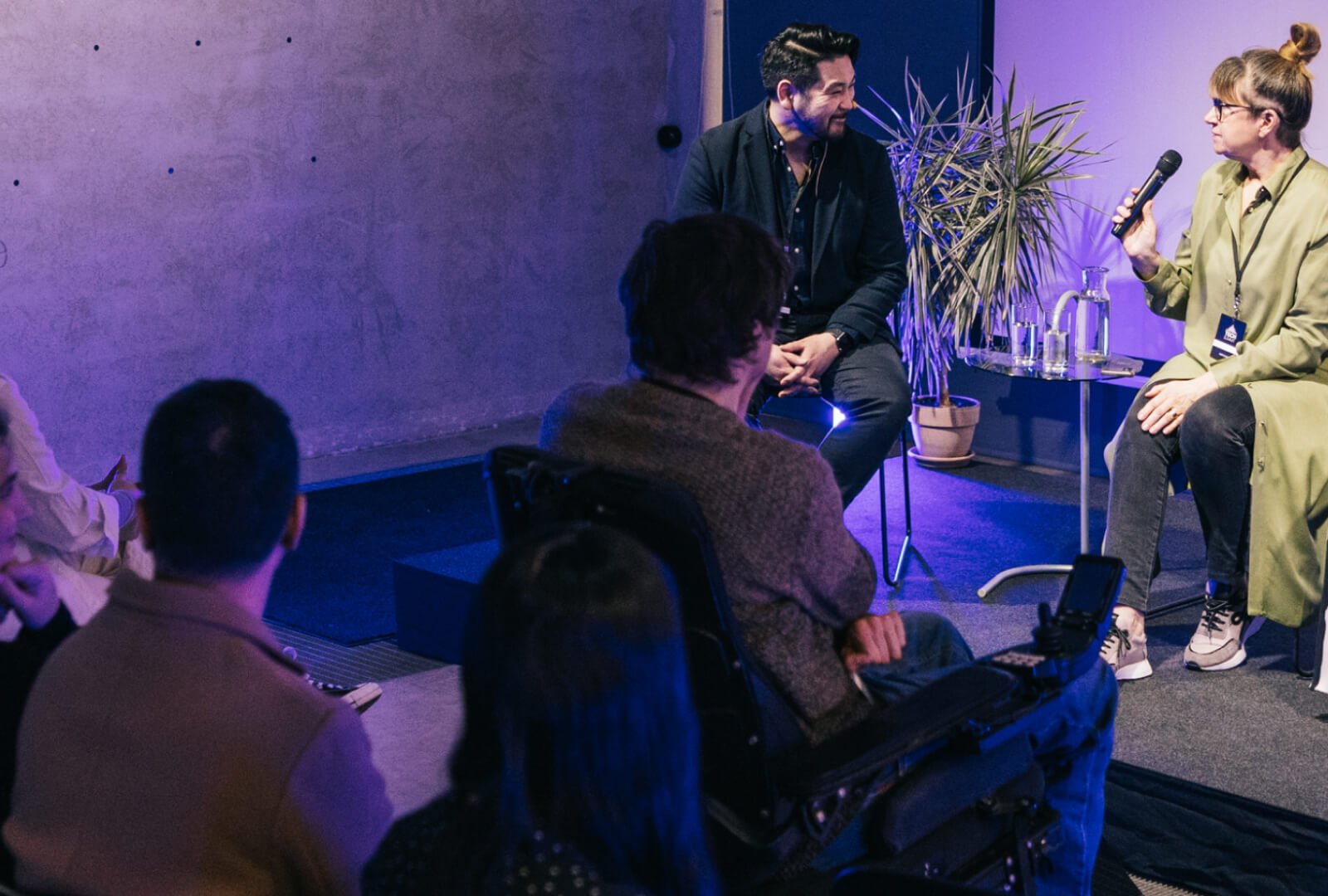 forum participant answering questions on a stage