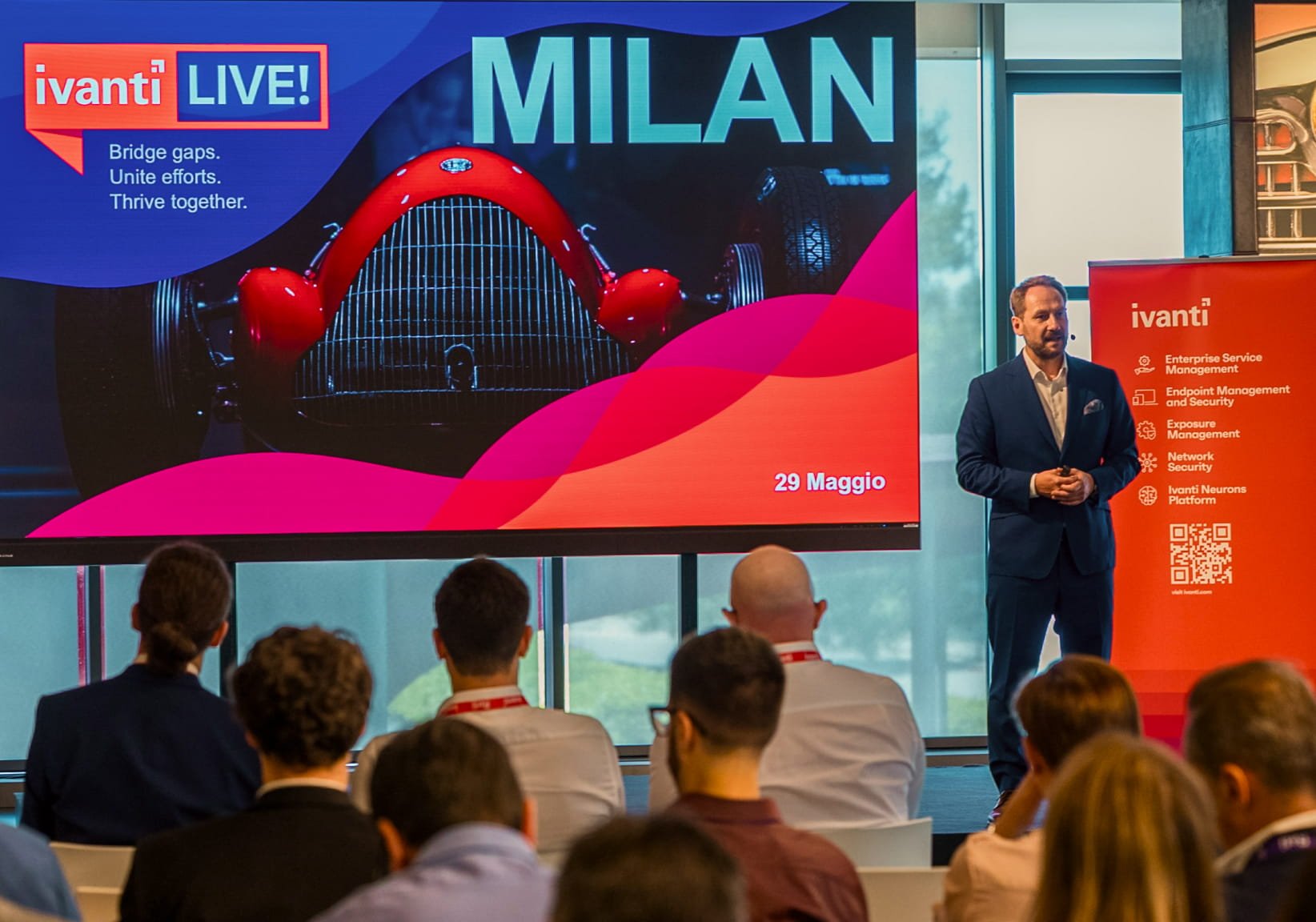 image of a male speaker on a stage