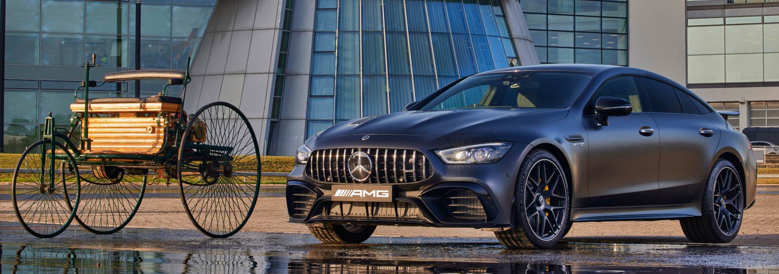 image of a historic mercedes cart and a modern mercedes benz