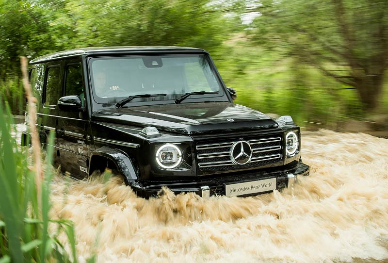 mercdes benz g-class offroad car crossing a river