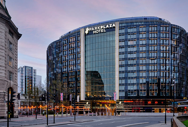 Modern Park Plaza Hotel façade on a city street at dusk