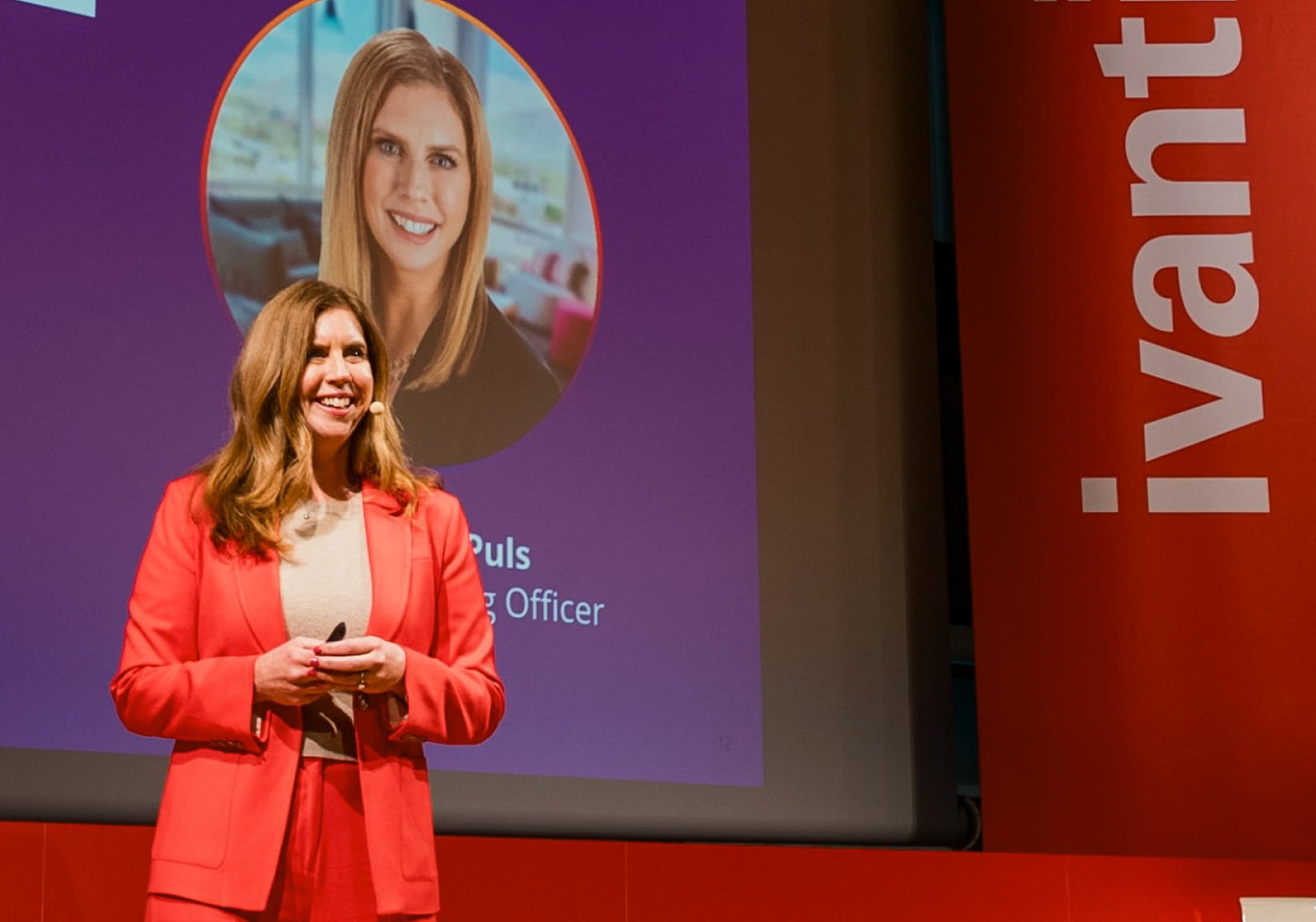image of a woman on a stage addressing the audience