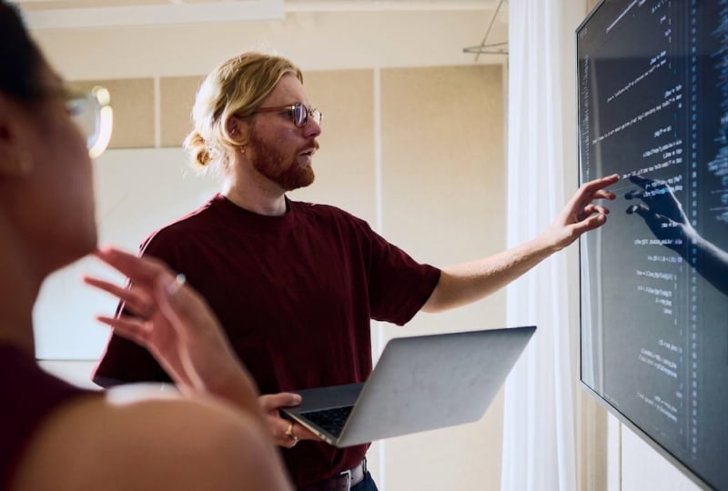 person using a touch screen monitor