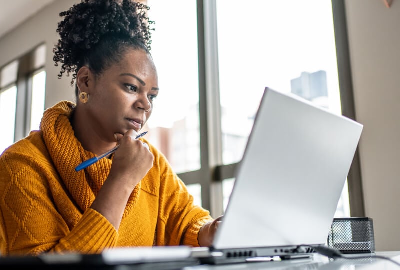 A woman working at a laptop