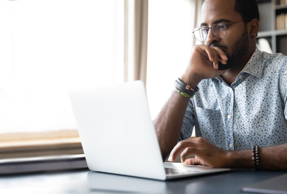 man looking at a laptop