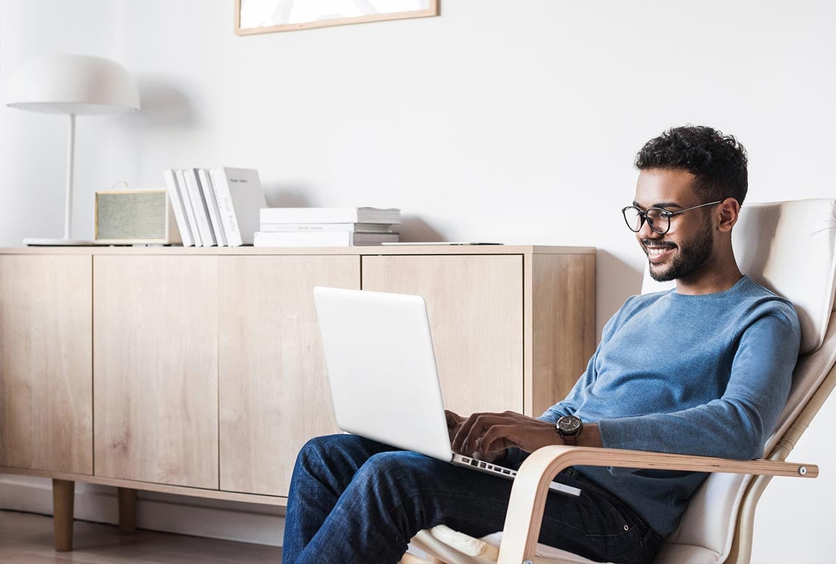 guy sitting in chair on his laptop