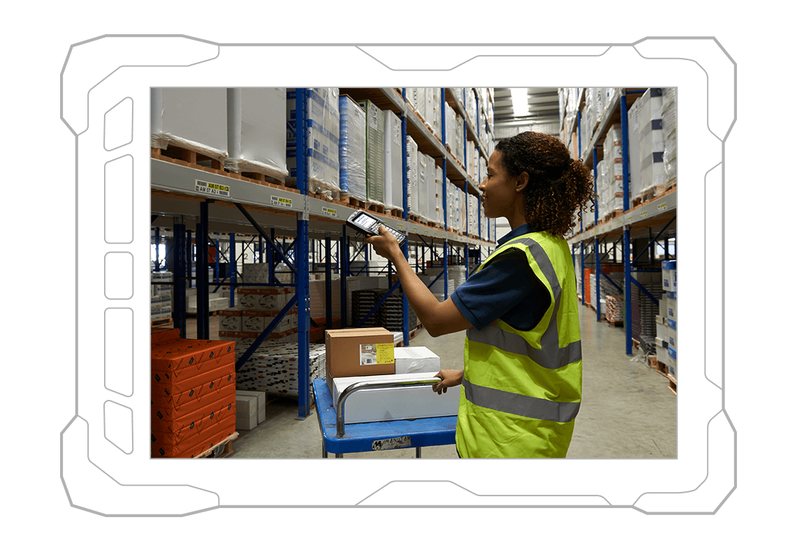 Smiling woman in a warehouse wearing a yellow reflective vest scanning items with a mobile scanning device.