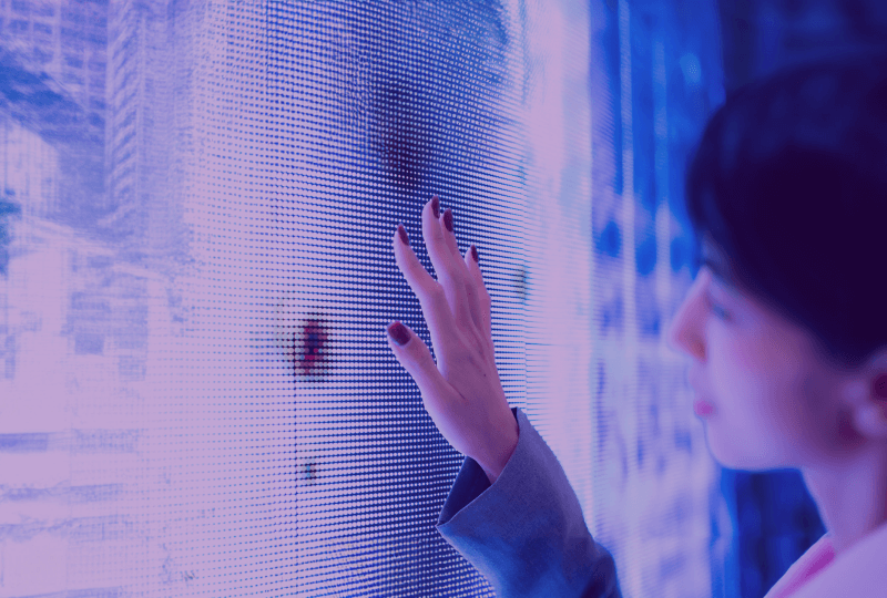 woman touching interactive monitor wall