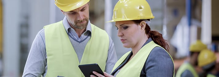 warehouse worker looking at data on a mobile device