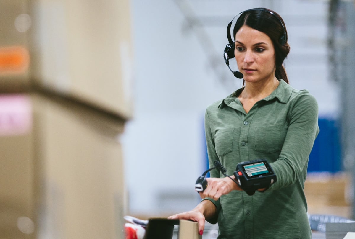woman wearing headset scanning items