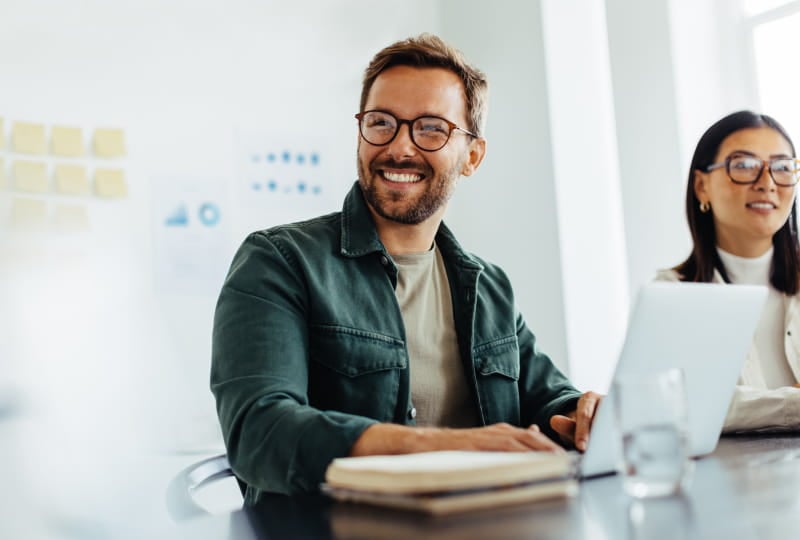 a man and a woman sitting in a conference room