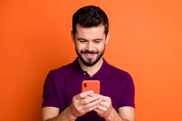 man on phone w orange case and background