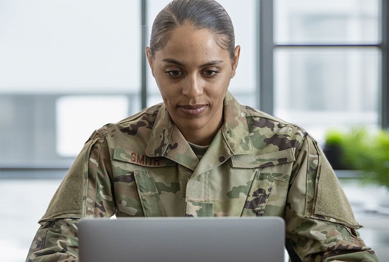 female soldier interacting with a laptop.
