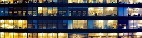 facade of an office building with lit windows