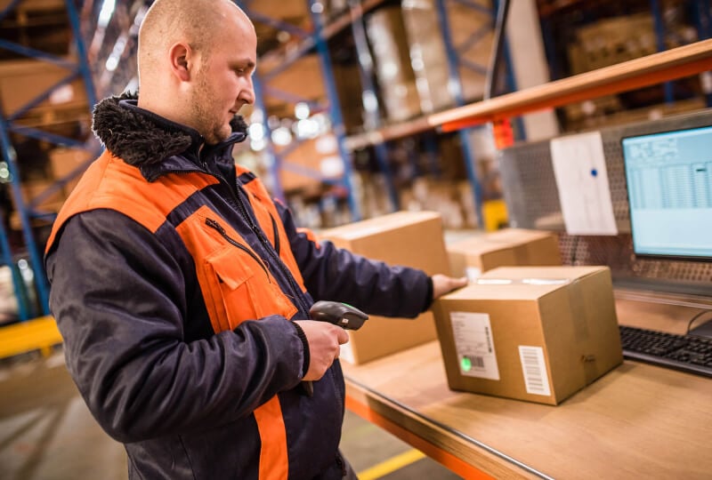 warehouse worker scanning incoming box