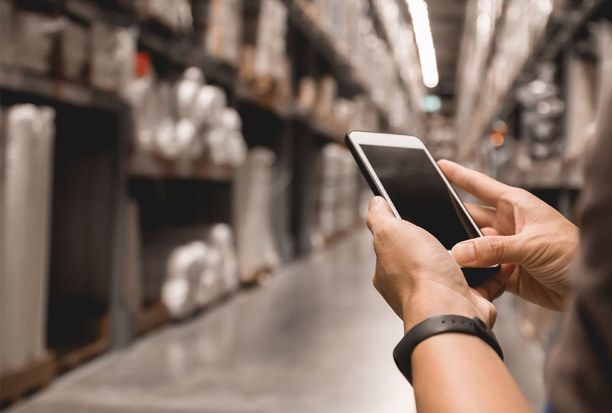 worker using mobile phone in a warehouse