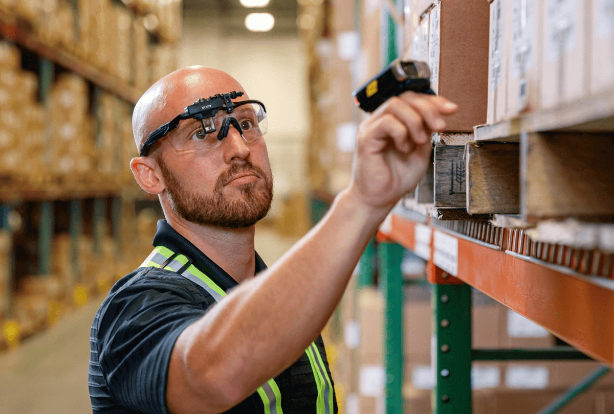 worker using mobile scanning device in a warehouse