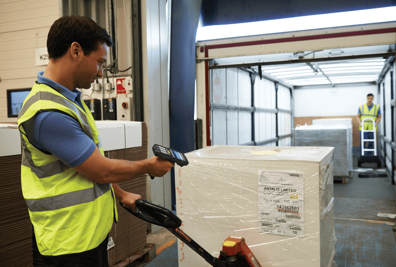 warehouse worker scanning incoming box