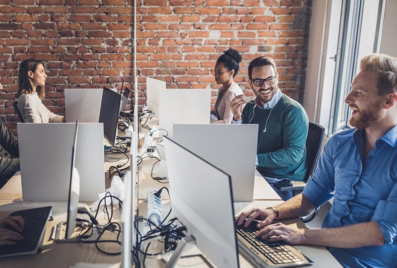 Group of happy computer programmers working in the office.