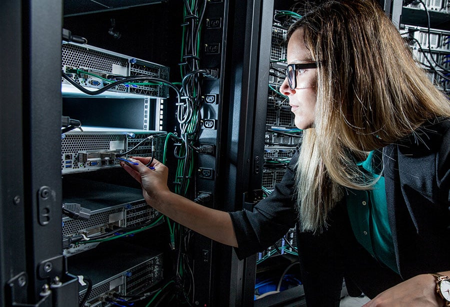 tech woman playing with wires in tech room