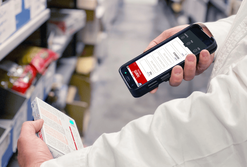 Person scanning an item with a smartphone scanner device