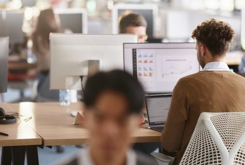 office workers using different computer devices