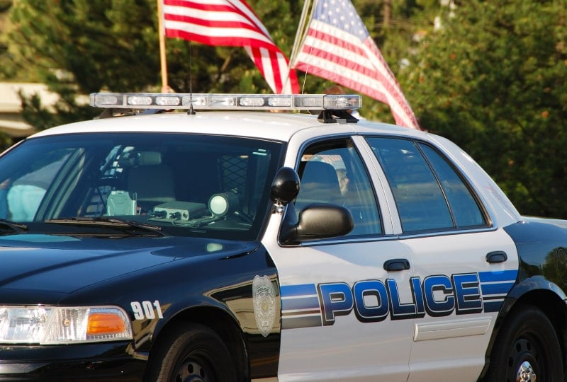 image of a police car and us flags